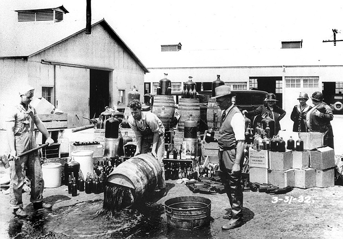 Merchant-and-Makers-Brief-History-of-Cocktails-7-Orange-County-Sheriff's-deputies-dumping-illegal-booze,-Santa-Ana,1932