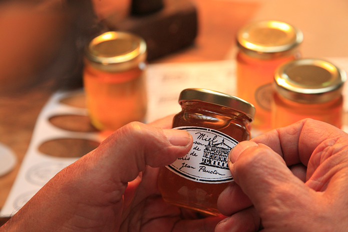Merchant-and-Makers-Honey-Gathering-38-Urban-Beekeeping--Paris-Opera-Garnier-Sticking-Labels-to-Honey-Jars